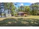 Spacious backyard with shade trees, a shed, chain link fence and peaceful views of the lake at 50 Silver Lake Dr, Mansfield, GA 30055