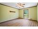 Light and airy bedroom features hardwood floors, a ceiling fan, and a window with green views at 50 Silver Lake Dr, Mansfield, GA 30055