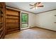Serene bedroom with a view of the backyard from its large window and built-in shelving at 50 Silver Lake Dr, Mansfield, GA 30055