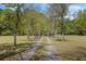 Long gravel driveway through a grassy lawn leading to a home at 50 Silver Lake Dr, Mansfield, GA 30055