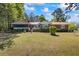 Ranch style home with a covered porch, screened in room, brick and siding and an expansive front yard at 50 Silver Lake Dr, Mansfield, GA 30055
