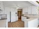 Well-lit kitchen featuring white cabinets, countertops, appliances, and wood-look vinyl flooring at 50 Silver Lake Dr, Mansfield, GA 30055