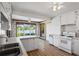 Kitchen features white cabinets, stainless steel sink, and views of the lake at 50 Silver Lake Dr, Mansfield, GA 30055