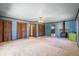 Spacious living room with carpet, ceiling fan, fireplace, multiple closets, and backyard access at 50 Silver Lake Dr, Mansfield, GA 30055