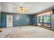Inviting living room with a lakeside view, a front entry door, carpeted floors, and a ceiling fan at 50 Silver Lake Dr, Mansfield, GA 30055