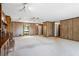 Bright living room with a ceiling fan, stone fireplace, and large windows at 50 Silver Lake Dr, Mansfield, GA 30055