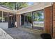 Brick patio with large sliding glass doors and views of the screened-in porch and lake at 50 Silver Lake Dr, Mansfield, GA 30055