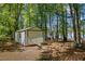 Large storage shed with ramp and rollup door is perfect for storing all your landscaping and lake toys at 50 Silver Lake Dr, Mansfield, GA 30055