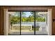 Sliding glass doors offering panoramic views of the lake and backyard at 50 Silver Lake Dr, Mansfield, GA 30055