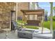 Cozy backyard patio with a swing bench, a modern fire pit and a stone accent wall at 5895 Springbox Dr, Suwanee, GA 30024