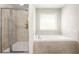 Well-lit bathroom with a tile shower and a soaking tub near a bright window at 5895 Springbox Dr, Suwanee, GA 30024
