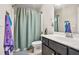 Bathroom featuring a shower/tub combination, toilet, and single sink vanity at 5895 Springbox Dr, Suwanee, GA 30024