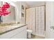 Cozy bathroom includes granite counters, decorative accents, and shower with curtain at 5895 Springbox Dr, Suwanee, GA 30024