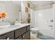 Bathroom features a shower-tub combination and a wooden vanity with a white sink at 5895 Springbox Dr, Suwanee, GA 30024
