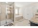 Primary bath with a tiled shower, soaking tub, double sinks, and granite countertops at 5895 Springbox Dr, Suwanee, GA 30024