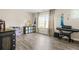 Playful bedroom featuring character decor, ample natural light, and hardwood flooring at 5895 Springbox Dr, Suwanee, GA 30024