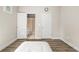 Neutral bedroom includes hardwood floors and an en suite bathroom at 5895 Springbox Dr, Suwanee, GA 30024