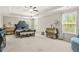 Spacious carpeted bedroom with a tray ceiling, plenty of windows and luxury furniture at 5895 Springbox Dr, Suwanee, GA 30024