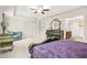 The main bedroom offers a tray ceiling, a dresser, and seating near a bright window at 5895 Springbox Dr, Suwanee, GA 30024