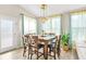 Bright dining room with table for eight, large windows and modern lighting at 5895 Springbox Dr, Suwanee, GA 30024