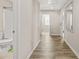 Hallway featuring laminate flooring, neutral walls, and access to rooms at 5895 Springbox Dr, Suwanee, GA 30024