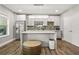 Updated kitchen features stainless steel appliances, quartz countertops, and tile backsplash at 5895 Springbox Dr, Suwanee, GA 30024