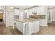 Gourmet kitchen with an island, modern appliances and granite counters at 5895 Springbox Dr, Suwanee, GA 30024