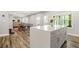 Kitchen featuring white cabinets and a gray kitchen island, with open layout to the living area at 5895 Springbox Dr, Suwanee, GA 30024