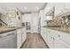 Modern kitchen featuring white cabinets, granite countertops, and stainless appliances at 5895 Springbox Dr, Suwanee, GA 30024