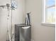 Small laundry room with ironing equipment, including a steamer and folding board at 5895 Springbox Dr, Suwanee, GA 30024