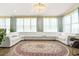 Spacious living room featuring a large white sofa and lots of natural light at 5895 Springbox Dr, Suwanee, GA 30024