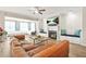 Bright living room with a fireplace, chandeliers and leather couch at 5895 Springbox Dr, Suwanee, GA 30024