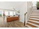 Inviting living room with fireplace, ample seating, and staircase access at 5895 Springbox Dr, Suwanee, GA 30024