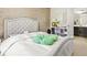 The main bedroom features a large bed with tufted headboard and a neutral wallpaper at 5895 Springbox Dr, Suwanee, GA 30024
