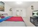 Comfortable main bedroom features neutral carpet, tv, and ensuite bathroom access at 5895 Springbox Dr, Suwanee, GA 30024