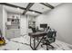 Spacious office features marble-look floors, built-in shelving, and a large desk at 5895 Springbox Dr, Suwanee, GA 30024