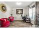 Bright office with hardwood floors, two plush pink chairs, a work desk, and natural light from a large window at 5895 Springbox Dr, Suwanee, GA 30024