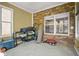 Bright sun room with brick accents and tile flooring, offering a relaxing atmosphere at 5895 Springbox Dr, Suwanee, GA 30024