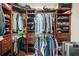 Organized walk-in closet with custom shelving and ample space for storage at 5895 Springbox Dr, Suwanee, GA 30024