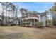Back of the house showcasing a balcony, covered patio, and a spacious lawn at 175 Oak Manor, Fayetteville, GA 30214