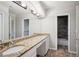 The bathroom has a granite countertop, dual sinks, wood look flooring, and a shower at 175 Oak Manor, Fayetteville, GA 30214