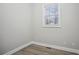 This empty bedroom has wood look flooring and a window that brings in natural light at 175 Oak Manor, Fayetteville, GA 30214