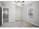 This bedroom has carpeted floors, a ceiling fan with lighting, and a window at 175 Oak Manor, Fayetteville, GA 30214