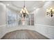 Dining area with decorative molding, large windows, hardwood floors, and a chandelier at 175 Oak Manor, Fayetteville, GA 30214
