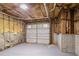 Unfinished attached garage with white door and brick details at 175 Oak Manor, Fayetteville, GA 30214