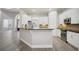 Bright kitchen with white cabinets, stainless steel appliances, granite countertops, and a breakfast bar at 175 Oak Manor, Fayetteville, GA 30214