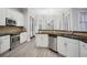 Kitchen with stainless steel appliances, granite countertops, white cabinetry, and hardwood floors at 175 Oak Manor, Fayetteville, GA 30214