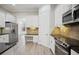 Kitchen features stainless steel appliances, granite countertops, custom cabinets, and hardwood floors at 175 Oak Manor, Fayetteville, GA 30214