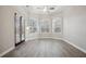 Spacious living room featuring neutral walls, stylish flooring, and a door to the patio at 175 Oak Manor, Fayetteville, GA 30214