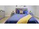 Cozy bedroom featuring blue bedding, decorative pillows, and neutral wall color at 24317 Plantation Ne Dr, Atlanta, GA 30324